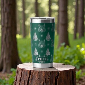 A green yeti tumbler engraved with squirrels, acorns, and trees. It is sitting on a stump with a forest in the background.